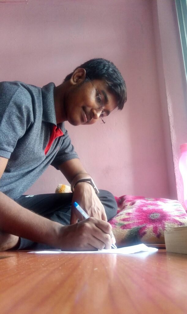 Person in sitting posture is writing with pen and paper.